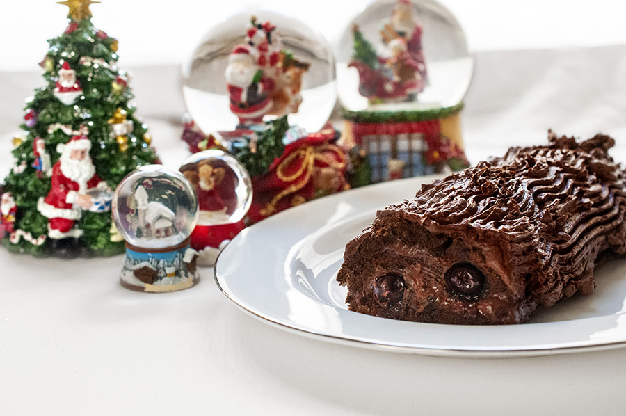 Christmas log with chocolate and black cherries